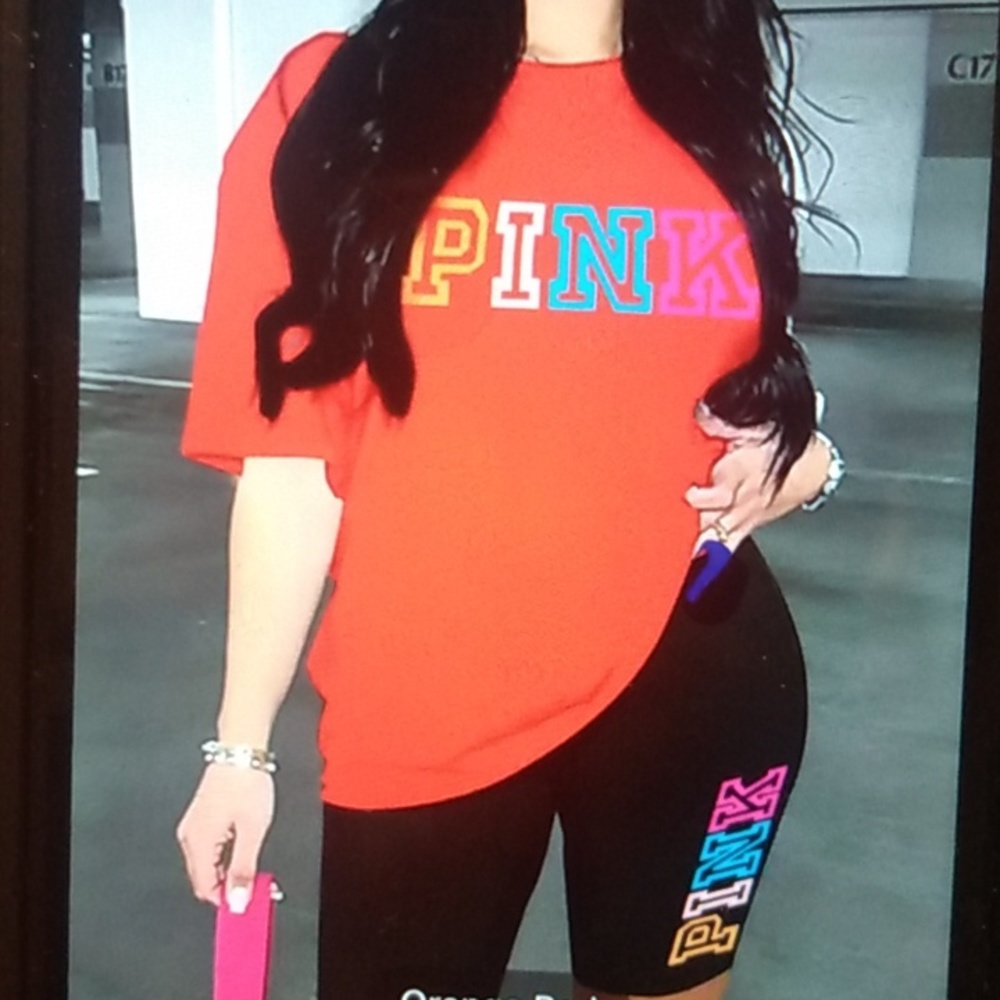 Pink Ladies Set Orange and black Shorts are legging material. NWOT